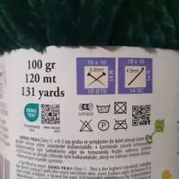Etykieta z informacjami o różnych rodzajach włóczek: 100g, 120m, 131 jardów. Wskazówki dotyczące rozmiaru drutów i oczek. Certyfikat OEKO-TEX®.