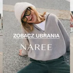 Kobieta w czapce i swetrze z wełny z merynosów, wesoło pozująca na tle ulicy.