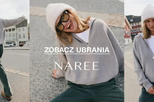 Kobieta w czapce i swetrze z wełny z merynosów, wesoło pozująca na tle ulicy.